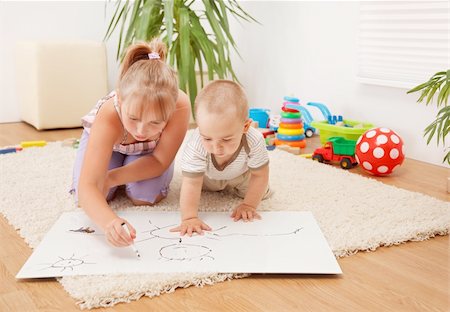 Brother watching his sister drawing on white sheet in the room Stock Photo - Budget Royalty-Free & Subscription, Code: 400-04715246