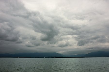 roxxer (artist) - Dark clouds during the stormy weather at Chiemsee lake in Germany. Fotografie stock - Microstock e Abbonamento, Codice: 400-04715971