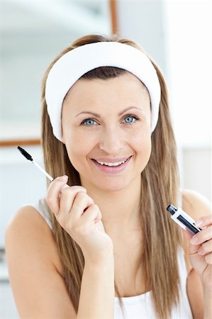 Radiant young woman using mascara in the bathroom at home Stock Photo - Budget Royalty-Free & Subscription, Code: 400-04716478