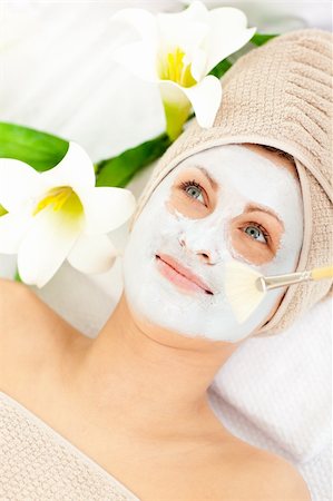 simsearch:400-04127590,k - Captivating young woman receiving white cream on her face in a spa center Stock Photo - Budget Royalty-Free & Subscription, Code: 400-04716535