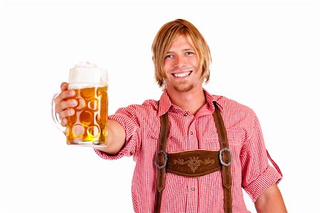 simsearch:400-04680527,k - Happy smiling man with leather trousers (lederhose) holds oktoberfest beer stein. Isolated on white background. Stockbilder - Microstock & Abonnement, Bildnummer: 400-04716605