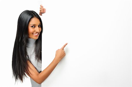 Cute Indian woman presents with a blank white board Photographie de stock - Aubaine LD & Abonnement, Code: 400-04717205