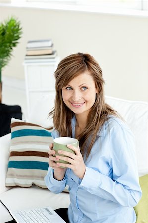 simsearch:400-04708507,k - pretty woman sitting at home working with laptop drinking coffee Stock Photo - Budget Royalty-Free & Subscription, Code: 400-04717235