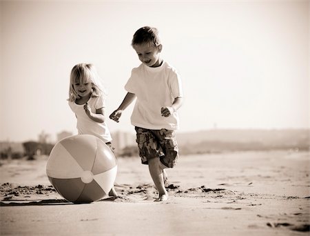 family playing with beach ball - Beautiful brother and sister play with a beach ball outdoors Stock Photo - Budget Royalty-Free & Subscription, Code: 400-04718367