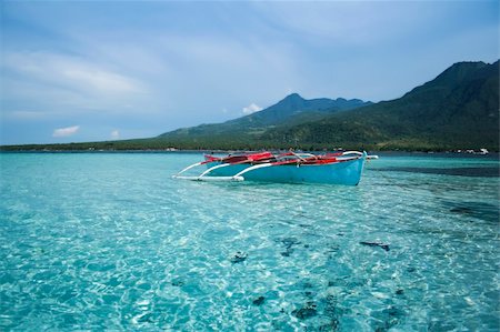 philippine fishing boat pictures - small outrigger traditional fishing boat in the clear seas of camiguin island near mindanao in the philippines Stock Photo - Budget Royalty-Free & Subscription, Code: 400-04719049