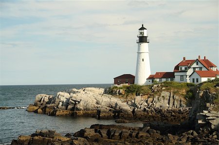 simsearch:6129-09086658,k - Portland Haed Lightouse in the distance on a rocky clif with partly cloudy skies. Stockbilder - Microstock & Abonnement, Bildnummer: 400-04719941