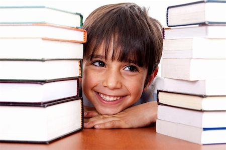 simsearch:400-04622918,k - Young kid relaxing between pile of books and looking away Stock Photo - Budget Royalty-Free & Subscription, Code: 400-04710269