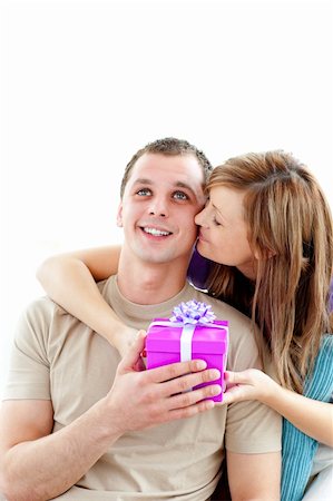 simsearch:400-06415374,k - Attractive boyfriend giving a present to his cute girlfriend against white background Stock Photo - Budget Royalty-Free & Subscription, Code: 400-04710338