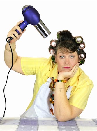 Totally bored frumpy housewife with hair rollers dries her hair. Stock Photo - Budget Royalty-Free & Subscription, Code: 400-04711396