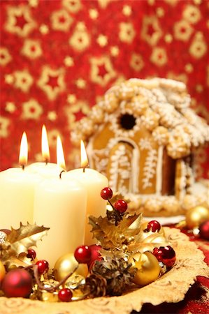 simsearch:400-05736949,k - Christmas decoration with four candles and gingerbread house on red Christmas background. Shallow DOF, copy space Foto de stock - Super Valor sin royalties y Suscripción, Código: 400-04711524