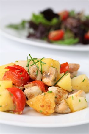 potato salad yellow - Fried potatoes with mushrooms and cherry tomatoes garnished with chives and sesame seeds. Shallow dof Stock Photo - Budget Royalty-Free & Subscription, Code: 400-04711527