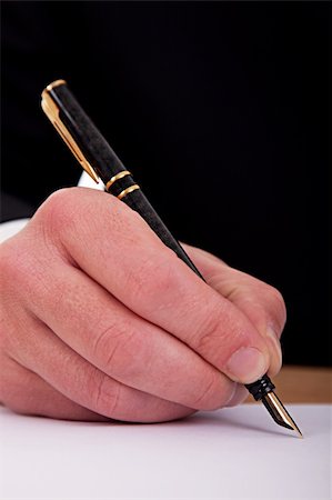 businessman signing a document  with a fountain pen isolated on a white background. Studio shot Photographie de stock - Aubaine LD & Abonnement, Code: 400-04711682