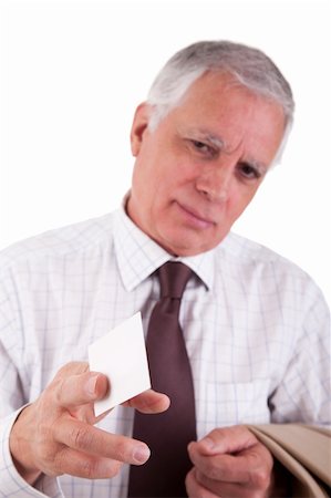 simsearch:400-04504842,k - Portrait of a mature  businessman, with blank business card in hand, isolated on white background. Studio shot. Photographie de stock - Aubaine LD & Abonnement, Code: 400-04711691