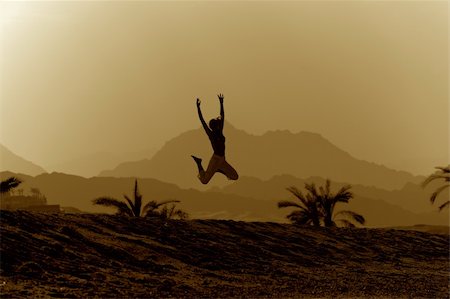 Jumping young woman on the mountan background in sepia tone. Stock Photo - Budget Royalty-Free & Subscription, Code: 400-04711720