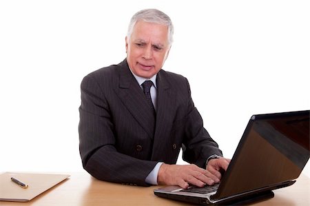 simsearch:400-04504842,k - mature businessman  working at computer, isolated on white background. Studio shot. Photographie de stock - Aubaine LD & Abonnement, Code: 400-04711738