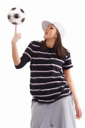 Young woman looks at the whirling soccer ball on her finger. Isolation on a white background in the studio. Stock Photo - Budget Royalty-Free & Subscription, Code: 400-04711741