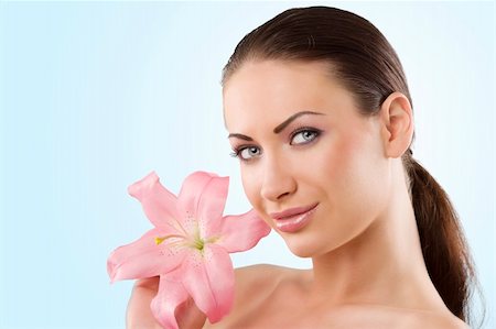 simsearch:400-06096871,k - wellness portrait of young woman with pink lily looking in camera with a smile Stock Photo - Budget Royalty-Free & Subscription, Code: 400-04712245