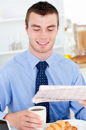 simsearch:400-05737647,k - Happy businessman reading the newspaper drinking coffee in the morning at home Stock Photo - Budget Royalty-Free & Subscription, Code: 400-04712937