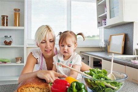 Merry young family preparing a salad in the kitchen Stock Photo - Budget Royalty-Free & Subscription, Code: 400-04712948