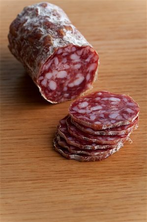 simsearch:400-04745282,k - slices of an a italian salami on an oak table Stock Photo - Budget Royalty-Free & Subscription, Code: 400-04713230