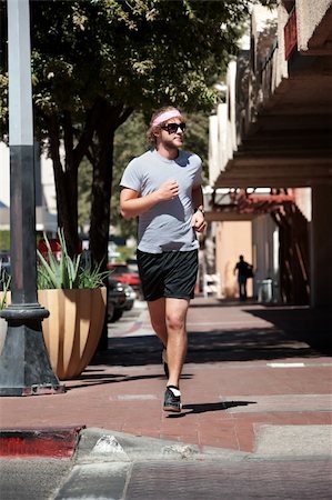 Single male out for a run in the city. Stock Photo - Budget Royalty-Free & Subscription, Code: 400-04713242