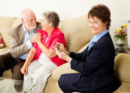financial advisor talking to couple - Successful saleswoman counting her money in the home of satisfied customers. Stock Photo - Budget Royalty-Free & Subscription, Code: 400-04713394