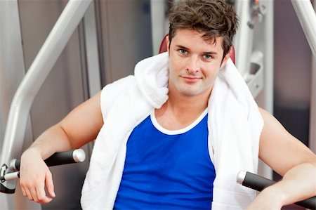 simsearch:400-04256139,k - Confident young man with a towel using a bench press in a fitness center Stock Photo - Budget Royalty-Free & Subscription, Code: 400-04724136