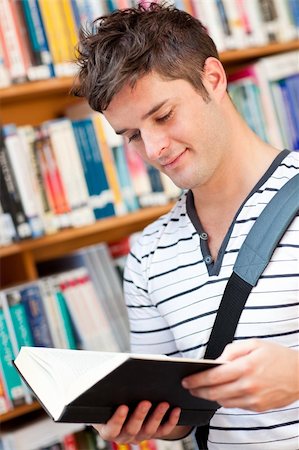 simsearch:400-04295114,k - Cute male student reading a book in a bookstore Photographie de stock - Aubaine LD & Abonnement, Code: 400-04724145