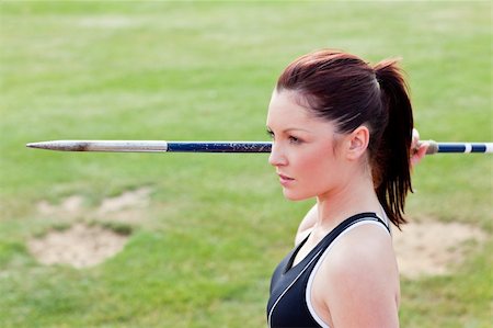 Concentrated athletic woman ready to throw the javelin in a stadium Stock Photo - Budget Royalty-Free & Subscription, Code: 400-04724140
