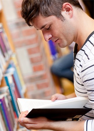 simsearch:400-04295114,k - Serious young man reading a book in a bookstore Photographie de stock - Aubaine LD & Abonnement, Code: 400-04724142