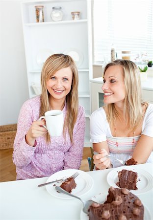 simsearch:400-04212407,k - Happy female friends eating a chocolate cake and drinking in the kitchen at home Stock Photo - Budget Royalty-Free & Subscription, Code: 400-04724746
