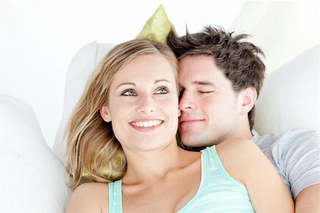 simsearch:400-06415374,k - Portrait of a hugging couple sitting on a sofa in the living-room at home Stock Photo - Budget Royalty-Free & Subscription, Code: 400-04724748