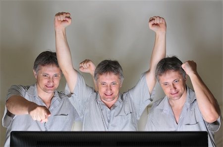 Three clones or triplets cheering at a television or computer screen Stock Photo - Budget Royalty-Free & Subscription, Code: 400-04725192