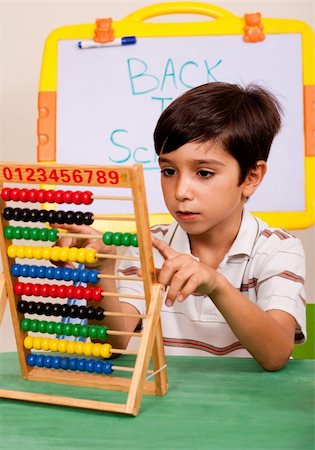 Young boy playing abacus in classroom enviroment Stock Photo - Budget Royalty-Free & Subscription, Code: 400-04725217