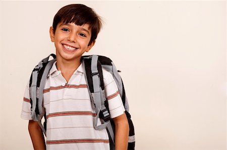 simsearch:400-04131892,k - Portrait of smiling schoolboy with back pack isolated on ivory background Stockbilder - Microstock & Abonnement, Bildnummer: 400-04725222