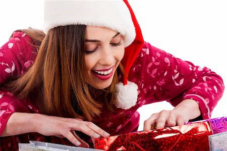 peeping fashion - closeup of young lady wearing christmas hat peeping into christmas gift bags Stock Photo - Budget Royalty-Free & Subscription, Code: 400-04725252