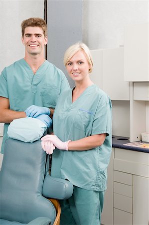 A happy dentist and assistant standing in a dental clinic Stock Photo - Budget Royalty-Free & Subscription, Code: 400-04725300