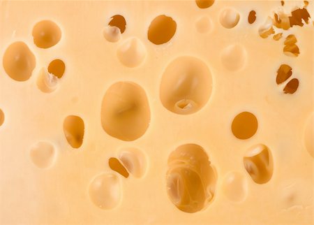 emmentaler cheese - Close-up of a cheese loaf whith holes Stock Photo - Budget Royalty-Free & Subscription, Code: 400-04725379