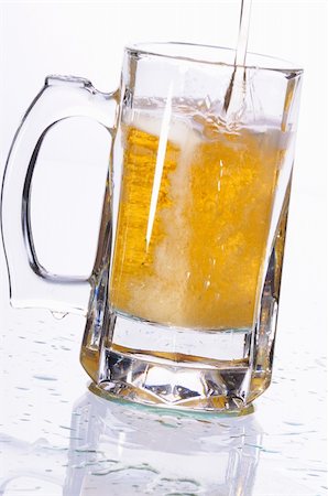 Mug with beer poured on a table Fotografie stock - Microstock e Abbonamento, Codice: 400-04727610