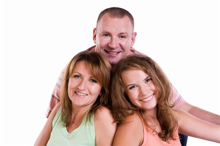 Happy family. Mother, father and daughter are smiling . Woman, man and girl are lying on the floor and posing happily on white background. Foto de stock - Super Valor sin royalties y Suscripción, Código: 400-04727705