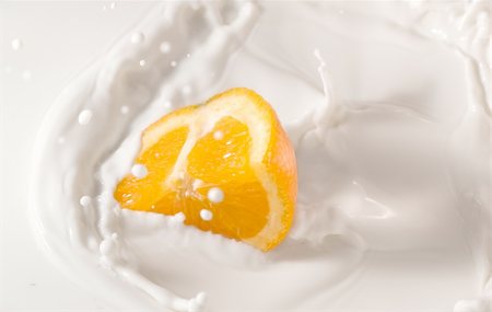 beautiful orange splash in a milk bowl Stock Photo - Budget Royalty-Free & Subscription, Code: 400-04727749