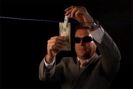 Mafia guy doing some serious money laundering Stock Photo - Budget Royalty-Free & Subscription, Code: 400-04727860