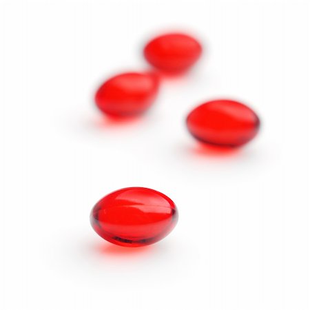 Red gel capsules. Selective focus. Isolated on white background. Stock Photo - Budget Royalty-Free & Subscription, Code: 400-04728398