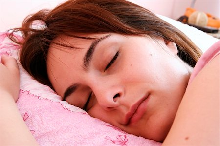 Beautiful young woman sleeping on bed in her bedroom at home in the morning. Fotografie stock - Microstock e Abbonamento, Codice: 400-04729281