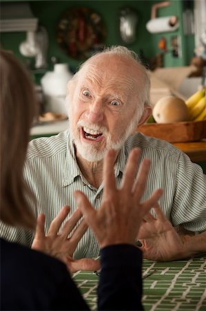 elderly couple concern - Senior couple at home in kitchen focusing on angry man Stock Photo - Budget Royalty-Free & Subscription, Code: 400-04729421