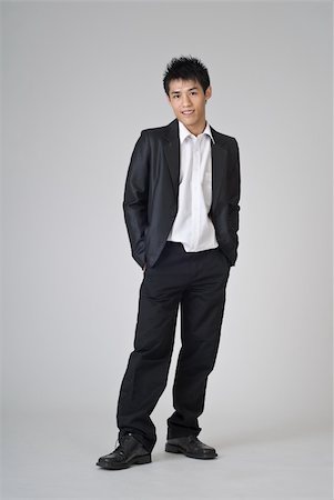 simsearch:400-04255435,k - Young business man of Asian standing on studio gray background. Foto de stock - Super Valor sin royalties y Suscripción, Código: 400-04729543