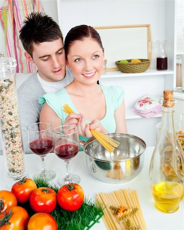 Close couple preparing spaghetti in the kitchen and drinkng wine at home Stock Photo - Budget Royalty-Free & Subscription, Code: 400-04720000