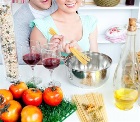 Close-up of an attractive couple cooking spaghetti in the kitchen at home Stock Photo - Budget Royalty-Free & Subscription, Code: 400-04720068