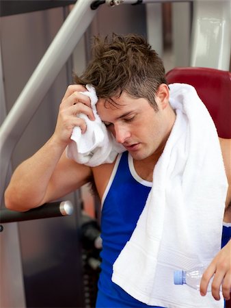 simsearch:400-04256139,k - Tired man using a bench press in a fitness center Stock Photo - Budget Royalty-Free & Subscription, Code: 400-04720174