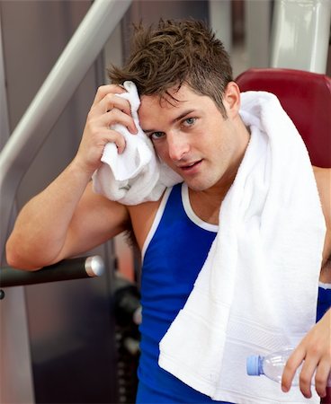 simsearch:400-05677914,k - Young man using a bench press in a fitness center Stock Photo - Budget Royalty-Free & Subscription, Code: 400-04720175